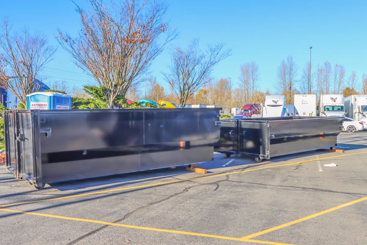 Professional dumpster rental service with roll-off container on residential driveway in Ste. Genevieve